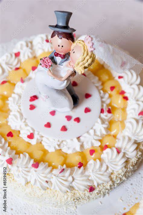 Sposi accanto a una torta nuziale decorata