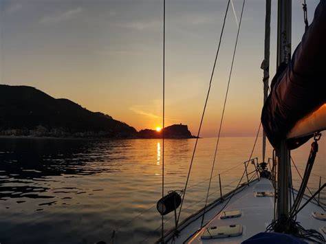 Barca a vela al tramonto in Liguria