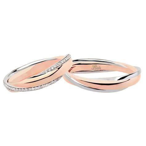 Esempi di fedi nuziali intrecciate in oro bianco e oro rosa