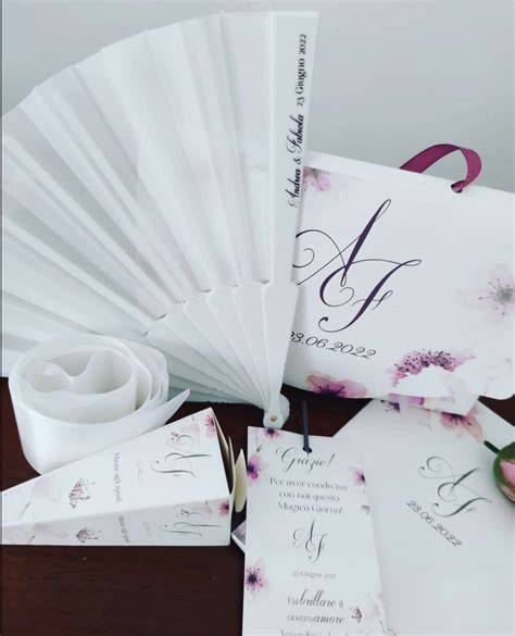 Contenuto di una wedding bag estiva con ventaglio, acqua e fazzoletti