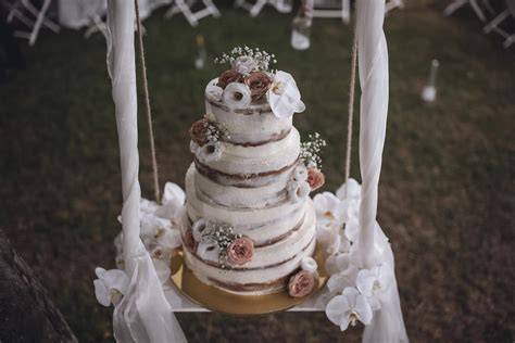 Struttura altalena per torta nuziale decorata con fiori
